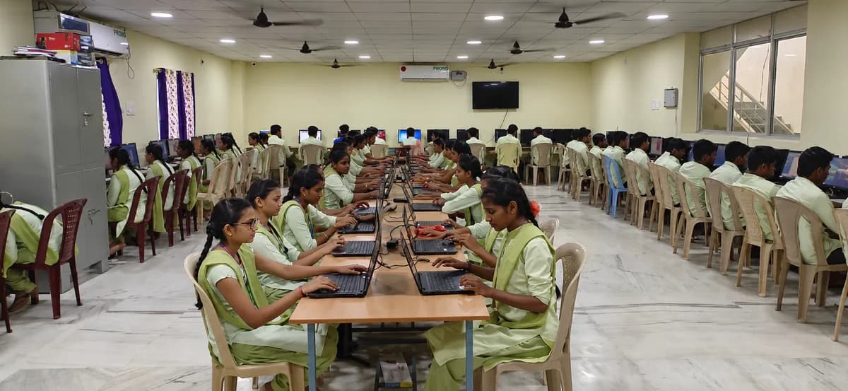Students at rows of desktop systems in the college computer center