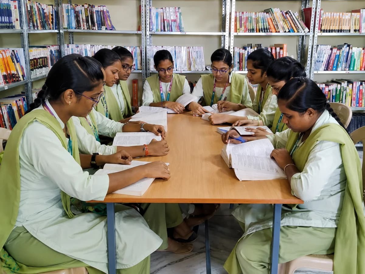 Students reading at tables in the college library